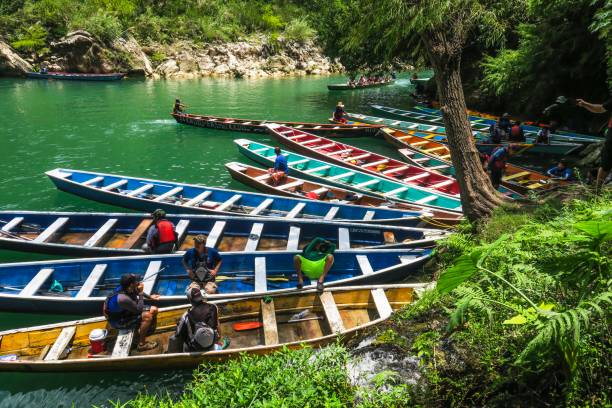 Guides resting among the colorful boats they use to take visitors to Huasteca Potosina waterfall in Mexico.