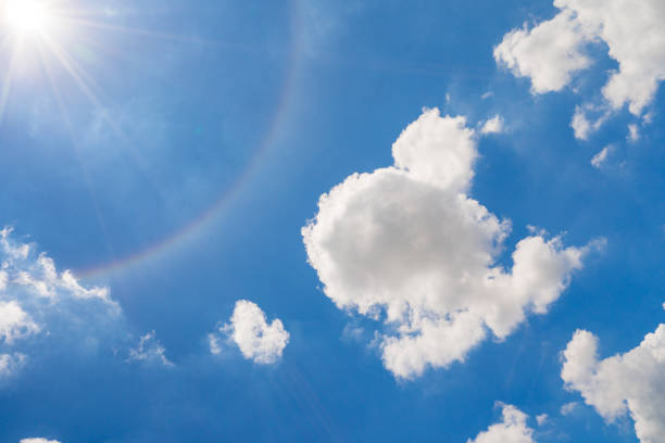 istock Vivid blue sky with white cloud and sun halo 1253465189