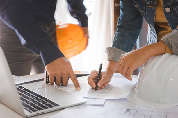 istock Architects are discussing and planning together at the desk with blueprints.construction & building concept. 1253465517