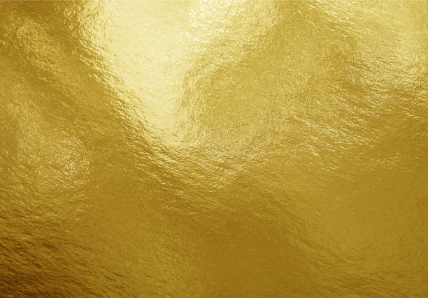 istock Gold foil texture background with highlights and uneven surface 1253467085