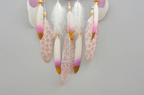 istock Yarn mandala with feathers and amethyst beads on grey background 1253467115
