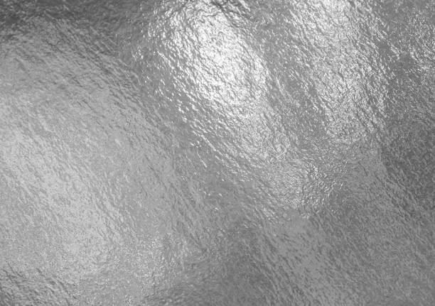 istock Silver shiny foil with highlights and uneven texture 1253467232