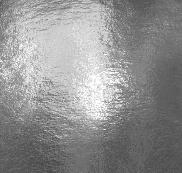 istock Silver shiny foil with highlights and uneven texture 1253467255