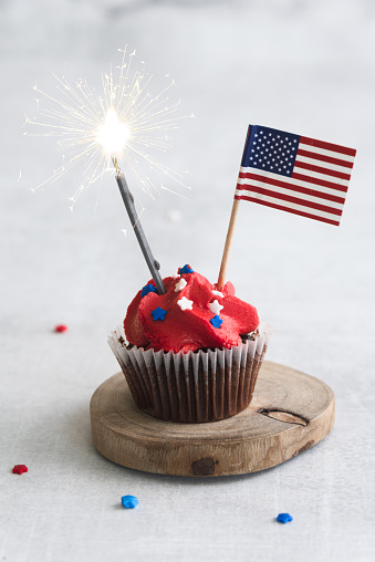 Patriotic 4th of July Cupcakes with sprinkles and flag
