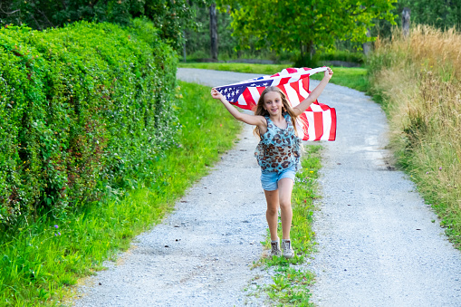 Cute girl running with American flag