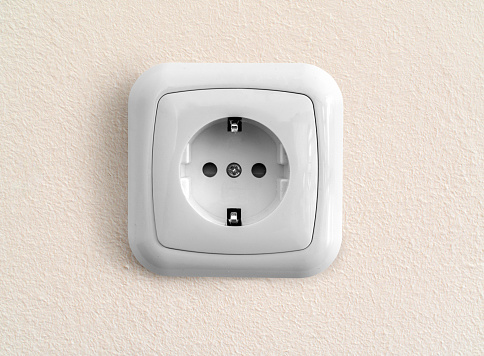 White european socket on renovated painted wall