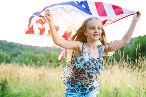 Cute girl running with American flag