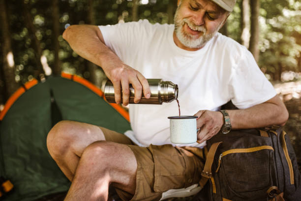 istock Man camping in nature taking rest and drinking fresh coffee 1253467666