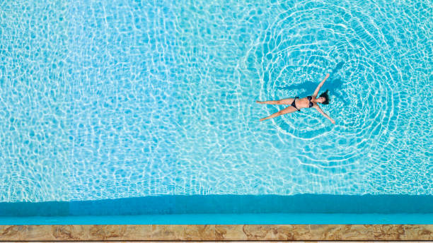 istock drone view of a woman relaxing floating on water 1253472327
