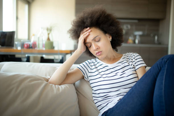 istock Sad woman suffering from a headache 1253472798