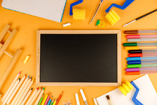 istock Various school supplies on orange background ready for your design. Back to school concept. 1253473953