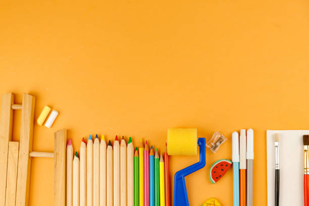 istock Various school supplies on orange background ready for your design. Back to school concept. 1253474075