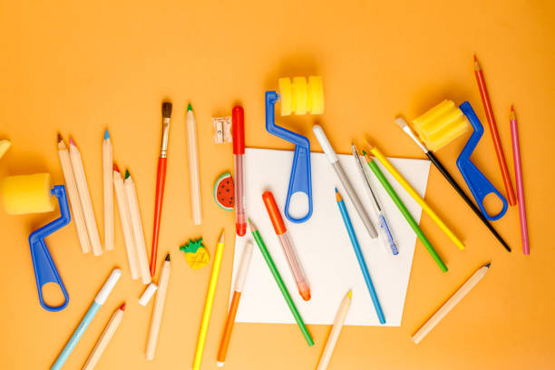 istock Various school supplies on orange background ready for your design. Back to school concept. 1253474157
