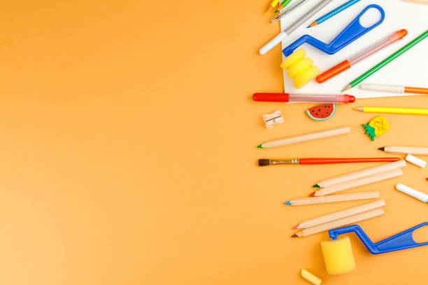 istock Various school supplies on orange background ready for your design. Back to school concept. 1253474239