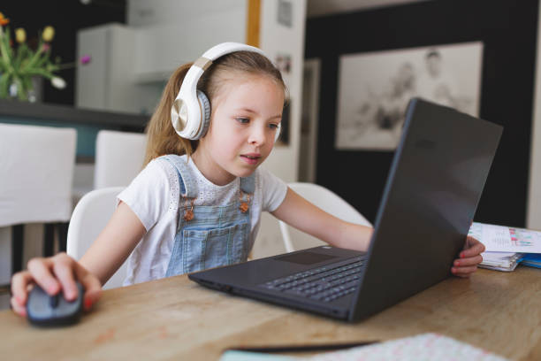 istock young girl with headphones and notebook 1253474366