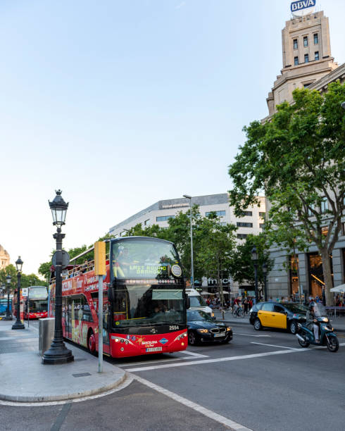 coach bus waiting at bus stop in plaza de catalunya (catalonia square), barcelona, spain - bus coach bus travel red imagens e fotografias de stock