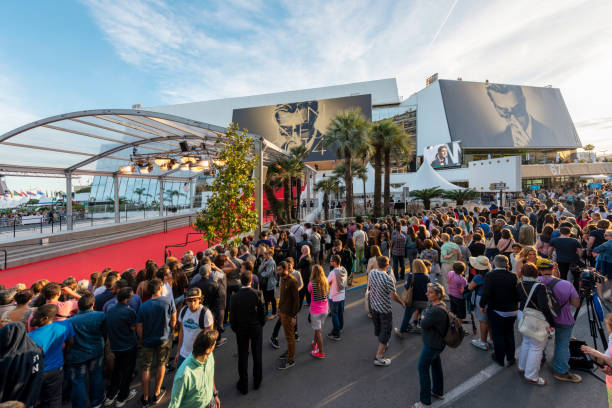 Cannes Film Festival Cannes, France - May 24, 2014: Great Auditorium of the exit door at Cannes in France, the famous red carpeted stairs and crowd of people waiting at the gate output. cannes film festival stock pictures, royalty-free photos & images