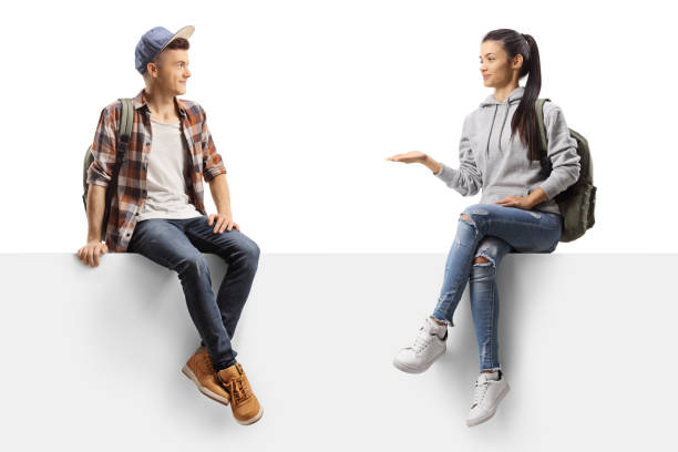 istock Female student talking to a male firend and sitting on a panel 1253476538