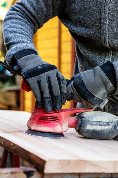 istock a man is sanding with an disk type sander or orbital sander a wooden board 1253477218