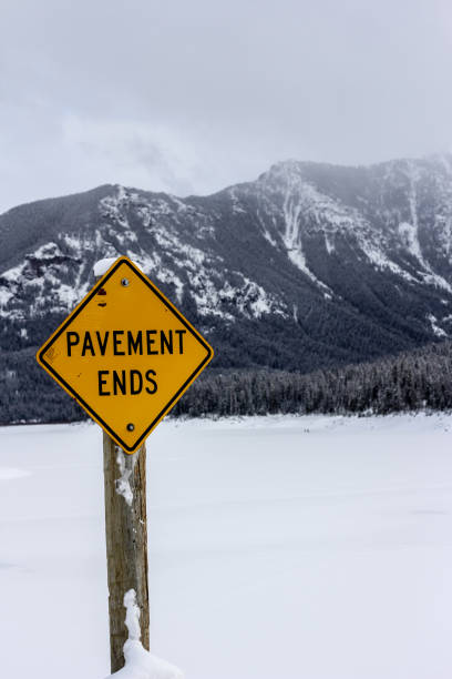 istock Mountains covered with snow with a road sign 1253477316