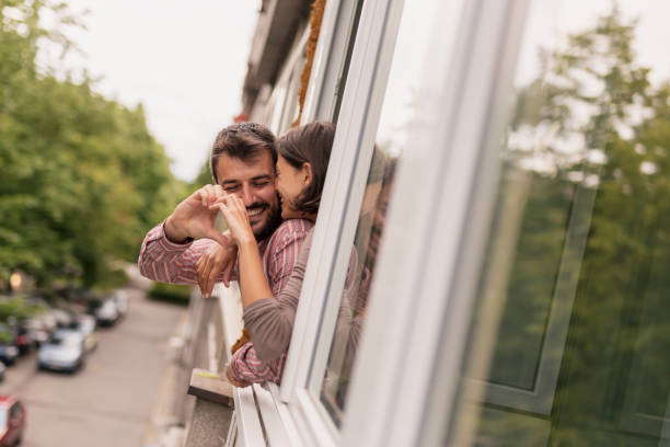 istock Couple standing by the window 1253479144