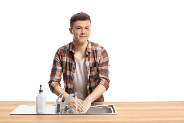 istock Young man washing hands and looking at the camera 1253482259