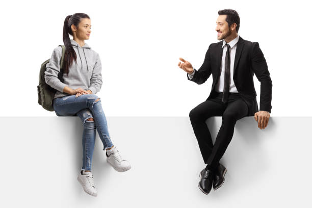 istock Female student and a businessman sitting on a panel and talking 1253482348