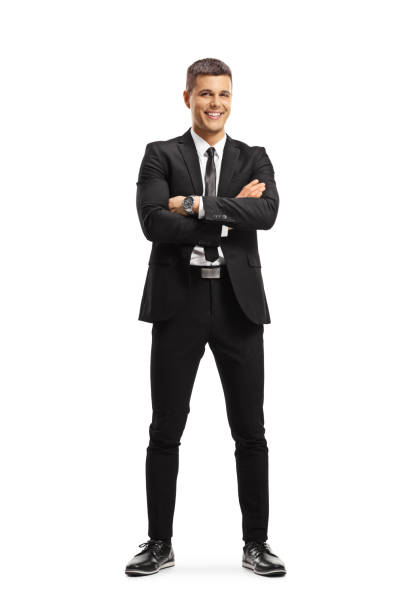 istock Young professional man in a suit posing with crossed arms 1253482472