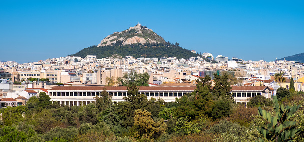 Scenic view of the city of Athens (Greece) with Lycabettus hill in the background and a blue sky with Copy-Space.