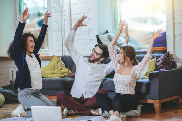 istock Three young students rejoicing in overall success. 1253484575