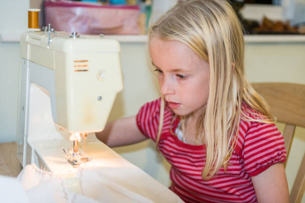 istock A young blonde girl using a sewing machine 1253487174