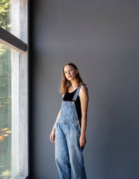 istock Young Woman in Overalls 1253488758