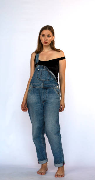 istock Young Woman in Overalls 1253488927