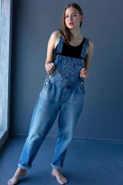 istock Young Woman in Overalls 1253489000