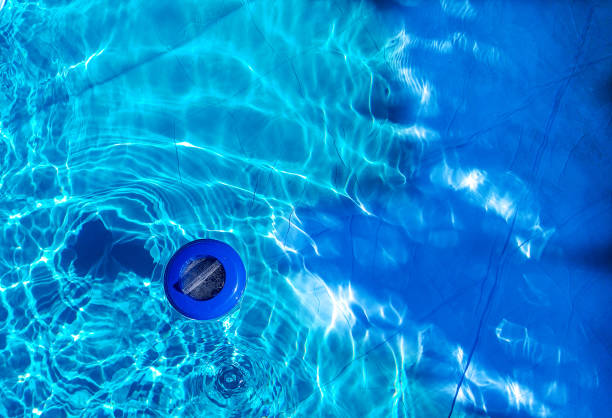 istock Floating plastic chlorine dispenser and blue water seen from above 1253493045