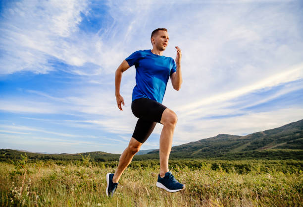 istock runner running summer mountain meadow 1253493153