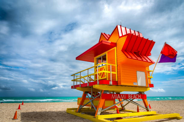 istock Cloudy sky over  a colorful lifeguard tower in South Beach 1253493156