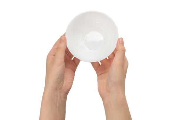 istock White bowl in woman hand isolated on white. 1253494009