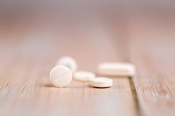 istock Home therapy. White round pills. Close-up 1253496405