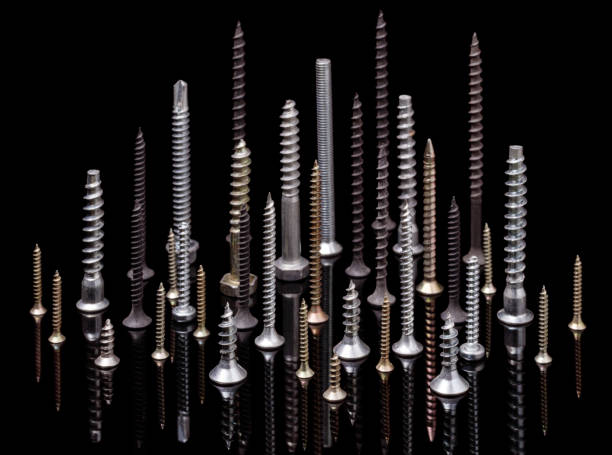 istock Group of different metal screws on black. 1253496498