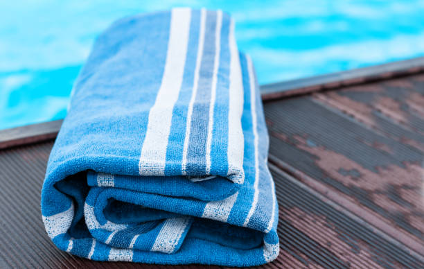 istock blue towel near swimming pool, tropical background 1253496711