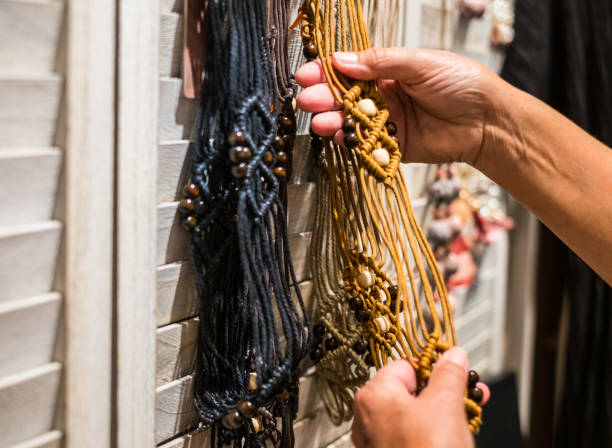 istock A woman's hands touch the necklaces in a craft store. Different accessories and bijouteries 1253496767