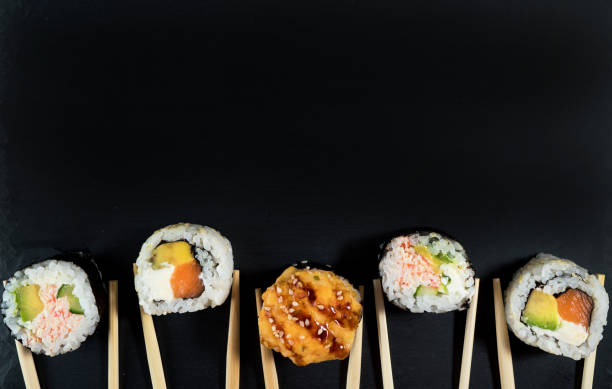istock Sushi roll set with chopsticks. Place for your text or logo. 1253498835