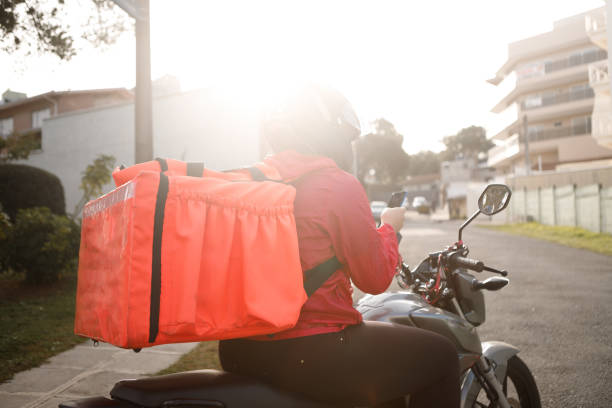 istock Delivery biker checking the address - motogirl 1253498884