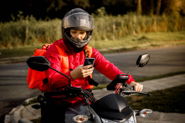istock Delivery biker arriving at destination - motogirl 1253498903