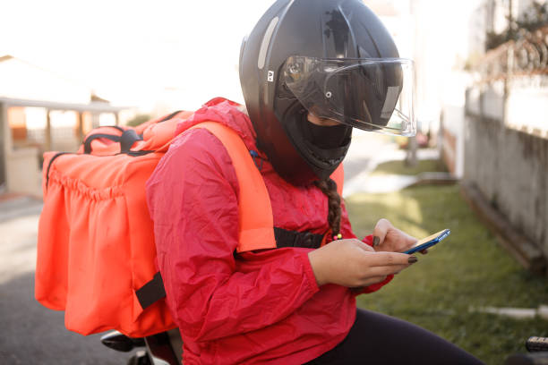 istock Delivery biker checking the address - motogirl 1253498957