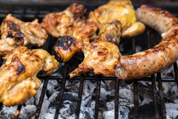 istock chicken and beef sausage, pork on a barbecue 1253499858