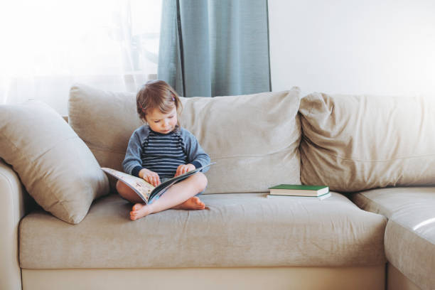 istock Girl reading at home. 1253499999