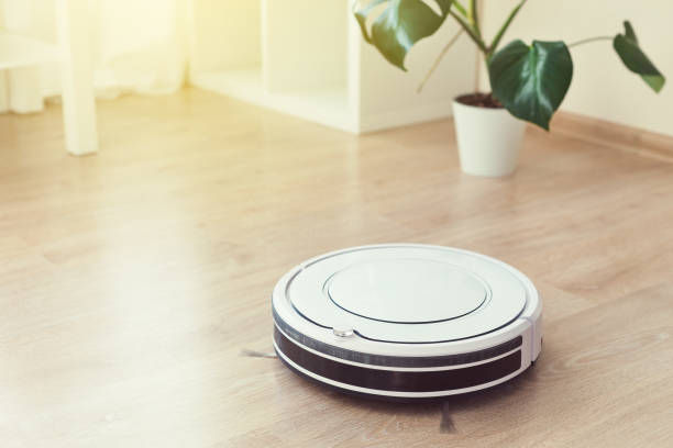 istock Robot vacuum cleaner cleaning floor 1253504336