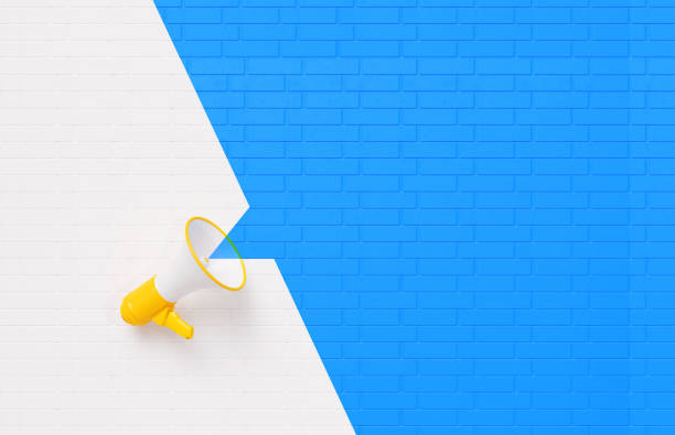 yellow megaphone on white and blue wall background - announcement message imagens e fotografias de stock